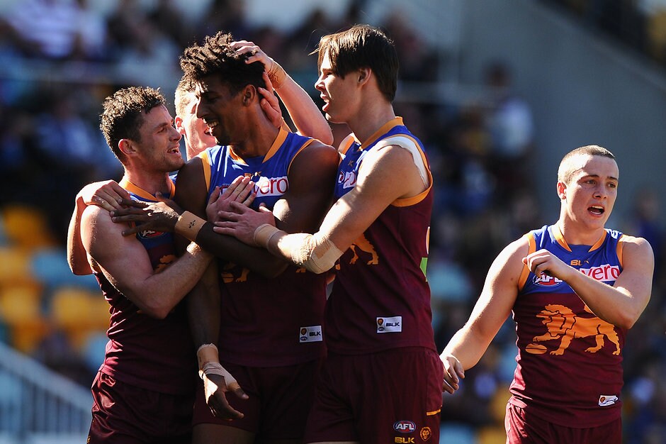 AFL 2016 Rd 21 - Brisbane v Carlton BRISBANE, AUSTRALIA - AUGUST 13: Archie Smith of the Lions celebrates kicking a goal with team mates during the 2016 AFL Round 21 match between the Brisbane Lions and the Carlton Blues at The Gabba on August 13, 2016 in Brisbane, Australia. (Photo by Matt Roberts/AFL Media)